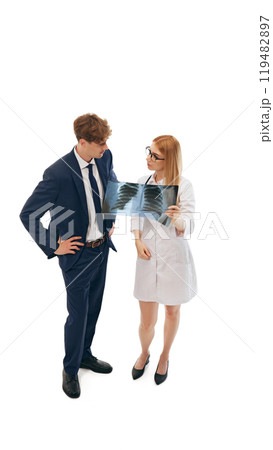 Doctor and businessman reviewing X-ray together, isolated on white background 119482897