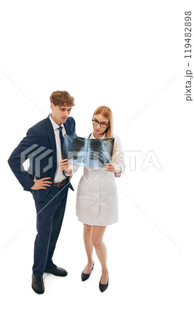 Female doctor, healthcare professional and businessman analyzing X-ray results 119482898