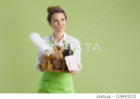 pensive modern woman isolated on green background pensive modern woman isolated on green background 119483221