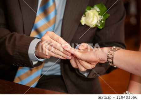 A Couple Beautifully Exchanging Rings in a Romantic Ceremony Filled with Joy and Love 119483666