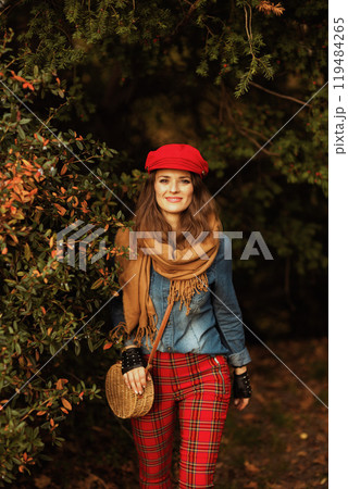 happy modern 40 years old woman in jeans shirt and red hat happy modern 40 years old woman in jeans shirt and red hat 119484265
