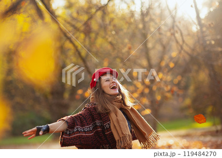 smiling elegant woman in red hat with scarf rejoicing smiling elegant woman in red hat with scarf rejoicing 119484270