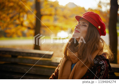 relaxed modern woman in red hat with scarf relaxed modern woman in red hat with scarf 119484274
