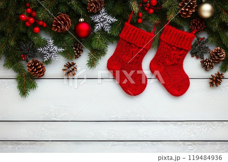 Christmas background. Christmas fir tree with decoration and red socks. Copy space, top view Christmas background. Christmas fir tree with decoration and red socks. Copy space, top view 119484936