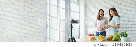 Banner Asian influencer vlogger live review healthy eating lifestyle. Banner Two woman friends blogger vlog happy lifestyle vegetables fruit salad. Two women talk social media vlog with copy space 119486632