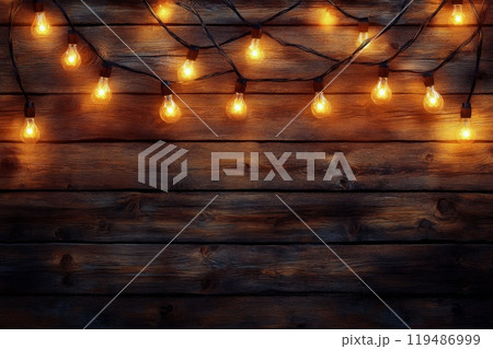 Warm string lights illuminate a rustic wooden wall in a cozy indoor setting at night 119486999
