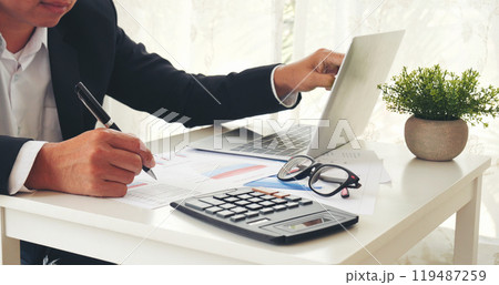 Close up business man hands using calculator counting tax financial bill. Man hands calculating number, data, graph, chart audit planning accountancy on business report. Tax audit Finacial concept. 119487259