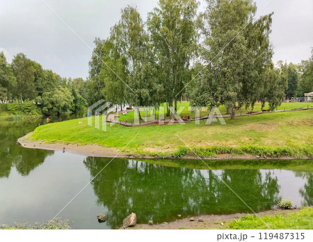 a beautiful bend of the river and trees with a wooden path in the eco park a beautiful bend of the river and trees with a wooden path in the eco park 119487315