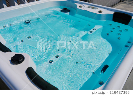 Close-up shot bubbling water in hot tub with headrests 119487393