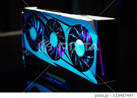 Close-up of high-performance graphics card with three cooling fans with neon lighting. Modern video card for gaming and advanced computing 119487445