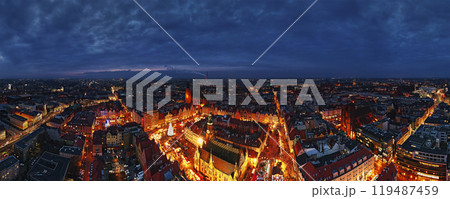 Aerial view of Christmas market at night with illuminated stalls, festive tree and historic buildings in Wroclaw, Poland. European town with decorated streets in winter season 119487459