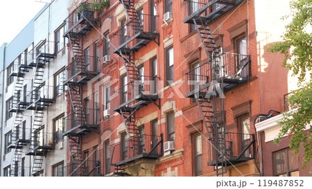 New York City building architecture, Manhattan. Residential house exterior. Red brick, fire escape. New York City building architecture, Manhattan. Residential house exterior. Red brick, fire escape. 119487852