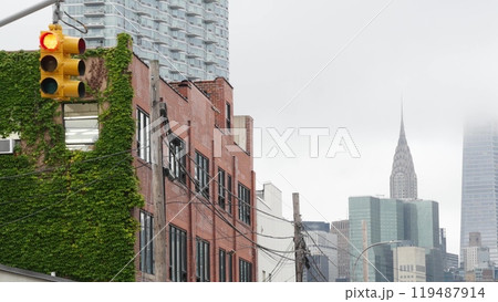 New York City street crossroad, yellow traffic light, transport road intersection, United States. 119487914