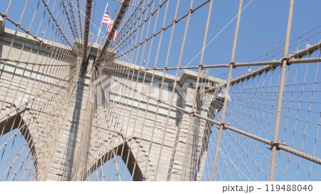 Brooklyn Bridge to Manhattan downtown, cables and blue sky. New York City iconic symbol. Travel USA. Brooklyn Bridge to Manhattan downtown, cables and blue sky. New York City iconic symbol. Travel USA. 119488040