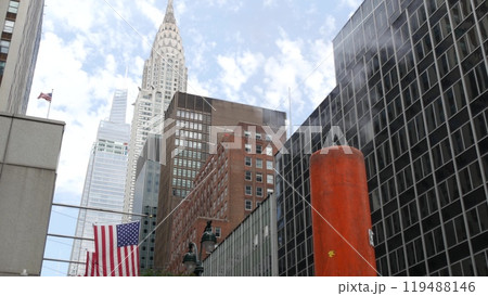 Steam vapor vented, New York City street steam system, orange vapour tube stack. Hot smoke from pipe 119488146