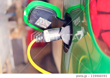 Eco friendly transport concept. Car electric charger station installed in residential complex. Charger for electric cars. Renewable energy. Eco friendly transport concept. Car electric charger station installed in residential complex. Charger for electric cars. Renewable energy. 119488391