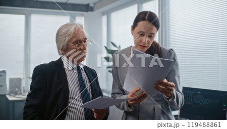 Female employee and team leader have discussion, analyze papers Female employee and team leader have discussion, analyze papers 119488861