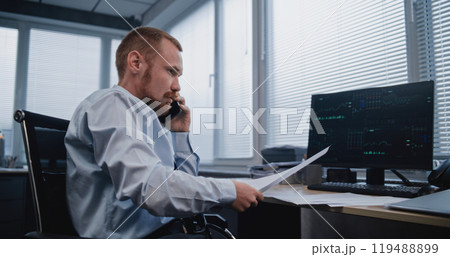 Analyst discussing results of sales department with colleague on mobile phone Analyst discussing results of sales department with colleague on mobile phone 119488899