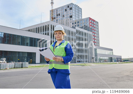 Confident mature female engineer developer inspector at construction site 119489066