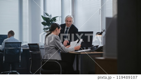 Two different business analysts, adult woman and senior man, discuss Two different business analysts, adult woman and senior man, discuss 119489107