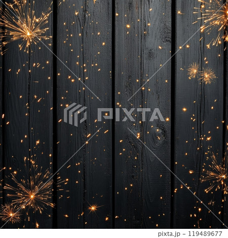Sparks flying across a wooden surface during a celebration at night with a dark background 119489677