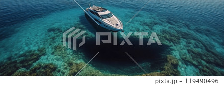 A luxury yacht cruises through clear blue waters on a sunny day in a tropical location 119490496