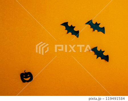 Halloween background, paper black bats and pumpkin on orange background. 119491584