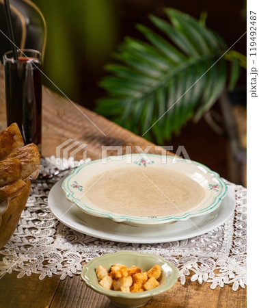 Creamy mushroom soup served on rustic wooden table with croutons and breadsticks Creamy mushroom soup served on rustic wooden table with croutons and breadsticks 119492487
