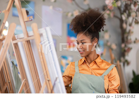 Young Girl Drawing in a Painting Studio with Colorful Artworks and Creative Environment 119493582