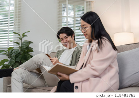 Mother and Son Enjoy Quality Time Together Relaxing in a Modern Living Room with Natural Light 119493763
