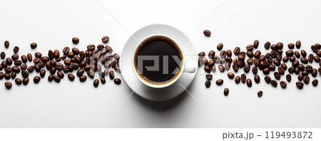 Top view of a cup of black coffee on a white saucer surrounded by scattered roasted coffee beans Top view of a cup of black coffee on a white saucer surrounded by scattered roasted coffee beans 119493872