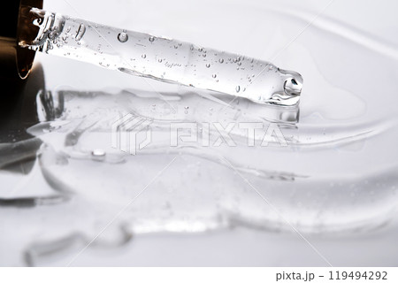 Dropper pipette with delicious serum with bubbles on the gel texture. 119494292