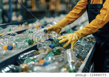 Worker Sorting Plastic Bottles on Assembly Line 119494773
