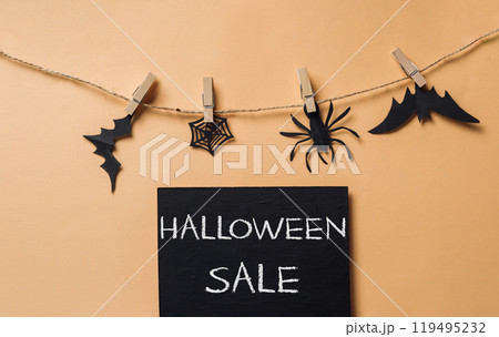 Halloween sale sign with black bats, spiders and a black and white spider Halloween sale sign with black bats, spiders and a black and white spider 119495232