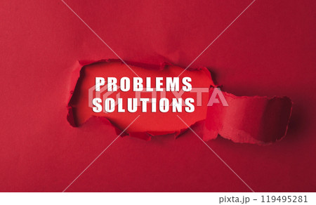 Red torn paper revealing the words problems solutions on a bold red background 119495281