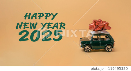 A green toy car with a red bow on top of it A green toy car with a red bow on top of it 119495320