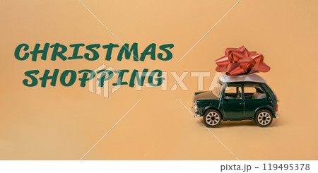 Green toy car with a red bow on top of it Green toy car with a red bow on top of it 119495378