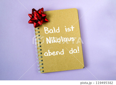 Notebook with a red bow on it Notebook with a red bow on it 119495382