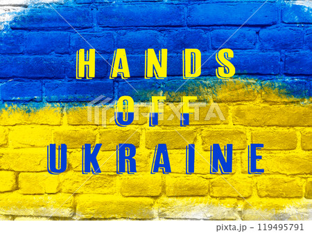 Blue and yellow brick wall with the words hands off ukraine written on it Blue and yellow brick wall with the words hands off ukraine written on it 119495791