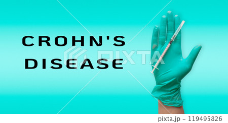 A hand holding a syringe with the words Crohn's Disease written below it A hand holding a syringe with the words Crohn's Disease written below it 119495826