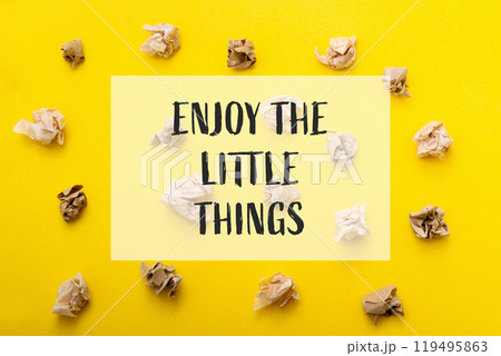 A yellow background with a pile of crumpled paper on it 119495863