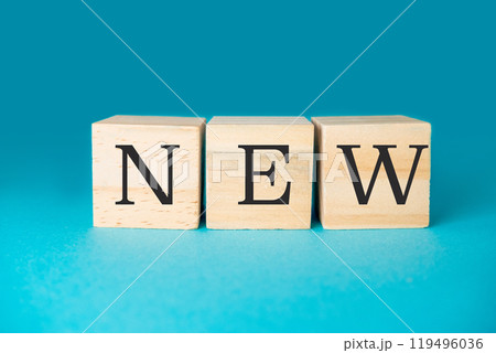 Three wooden blocks with the word NEW written on them Three wooden blocks with the word NEW written on them 119496036
