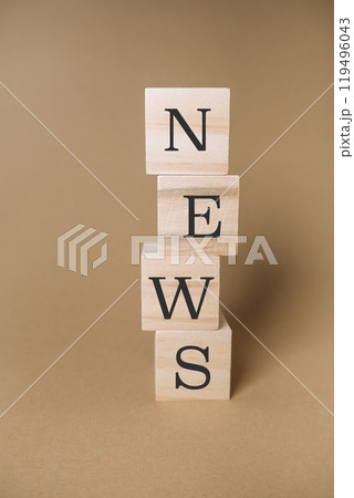 A stack of wooden blocks spell out the word news 119496043