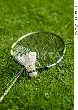 Badminton racket and shuttlecock on grass background. High quality photo Badminton racket and shuttlecock on grass background. High quality photo 119496310