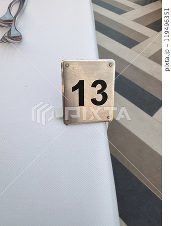 Dinner table place setting table card number thirteen . High quality photo 119496351