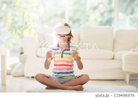 Child in virtual reality goggles. VR set for kids. Child in virtual reality goggles. VR set for kids. 119496976