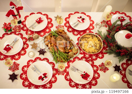 Christmas dinner at fire place and Xmas tree. 119497166