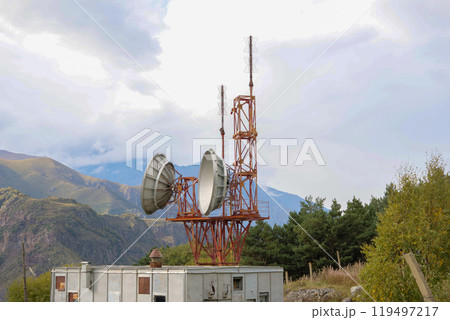 Telecommunications satellite dish radio telescope in mountains. Earth based astronomical locator Telecommunications satellite dish radio telescope in mountains. Earth based astronomical locator 119497217