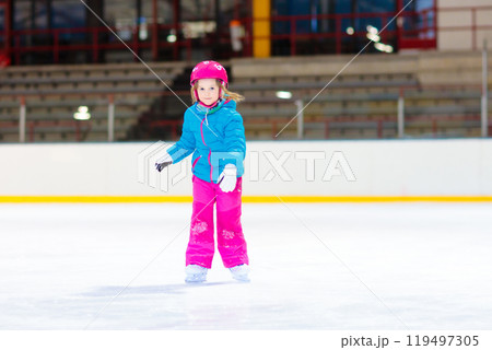 Child skating on indoor ice rink. Kids skate. Child skating on indoor ice rink. Kids skate. 119497305