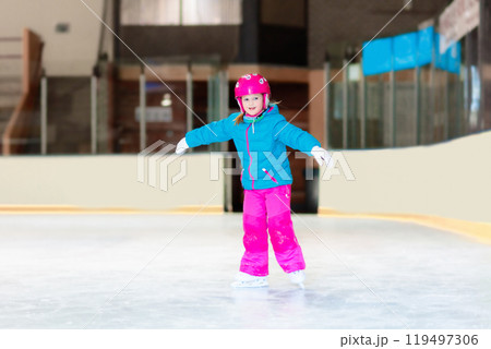 Child skating on indoor ice rink. Kids skate. 119497306